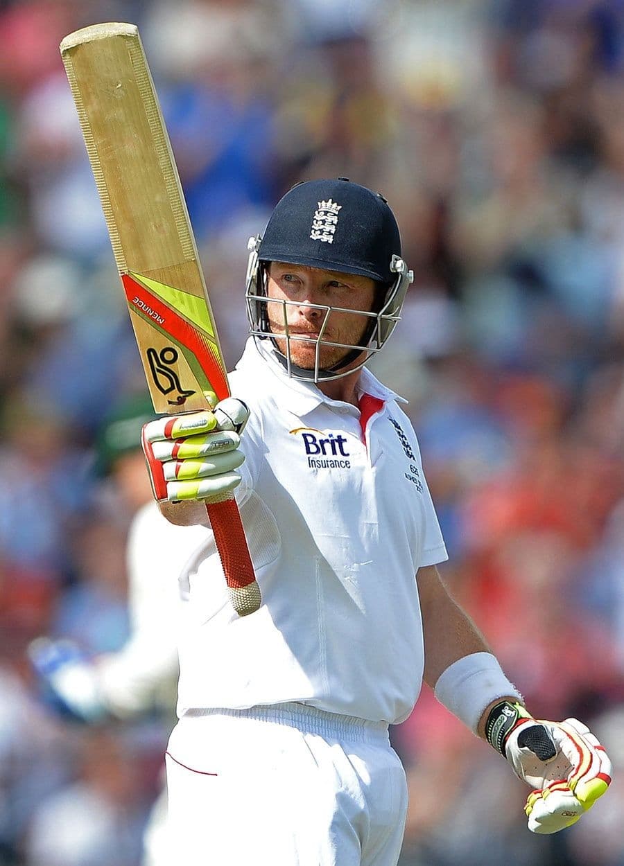 A batsman in whites playing a shot